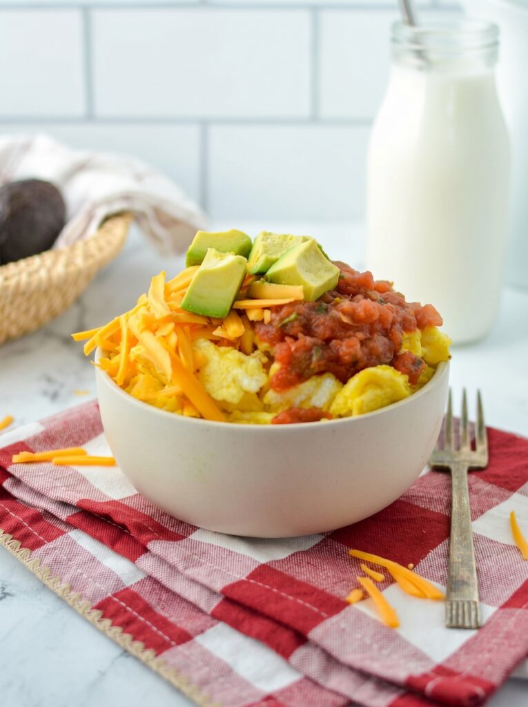 Breakfast Burrito Bowl with eggs, cheddar cheese, salsa, and avocado