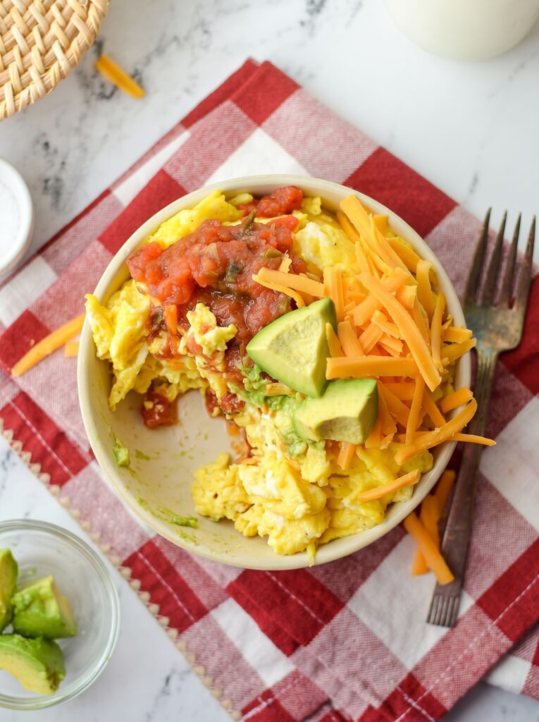 Breakfast Burrito Bowl with scrambled eggs, cheddar cheese, avocado, and salsa