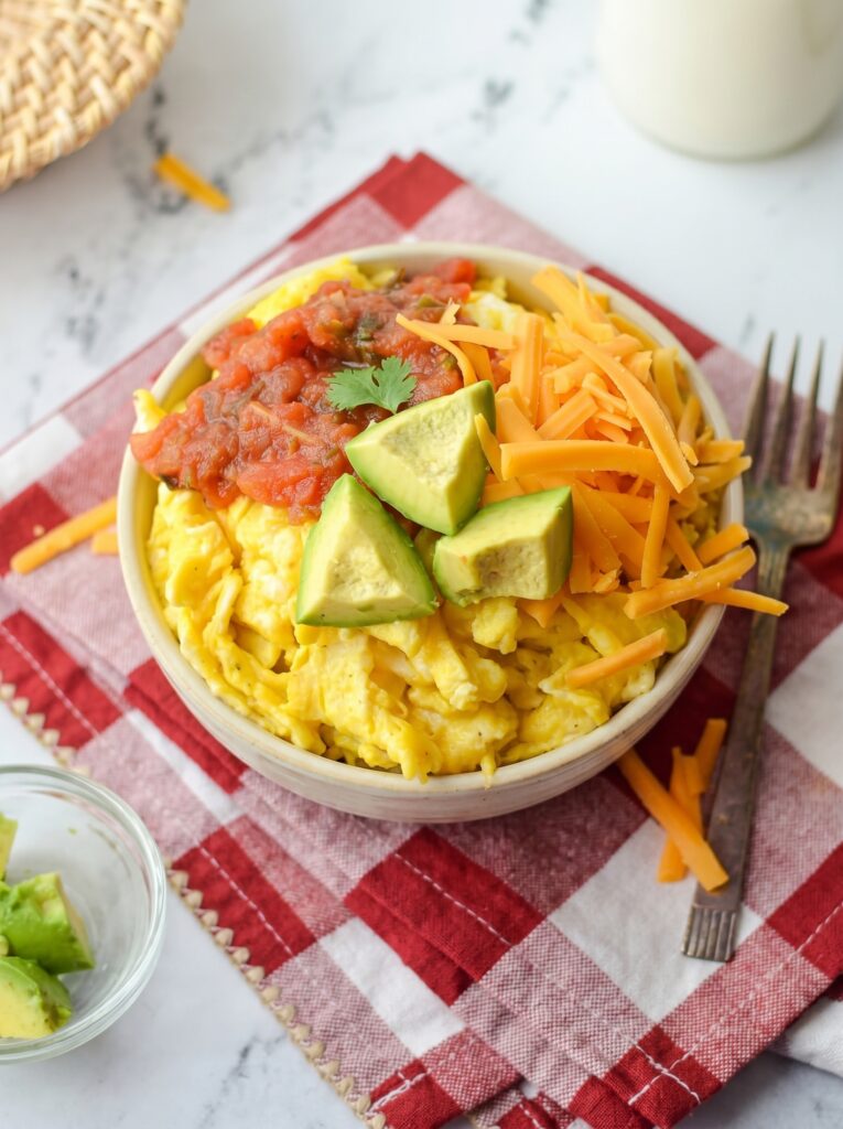 Breakfast Burrito Bowl with eggs, cheddar cheese, salsa, avocado, and cilantro